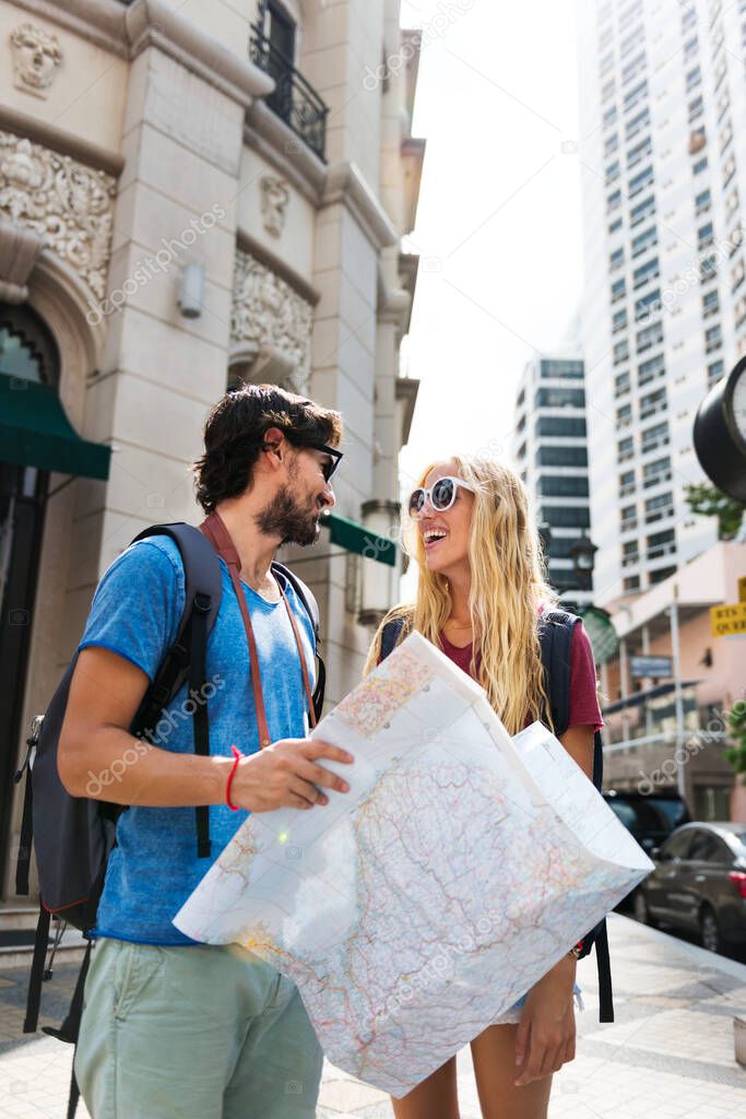 Couple holding a map, planning their next destination