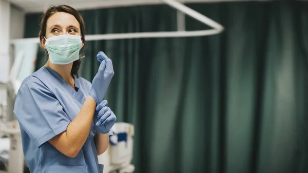 Enfermeira Feminina Com Uma Máscara Colocando Luvas Preparando Para Curar — Fotografia de Stock