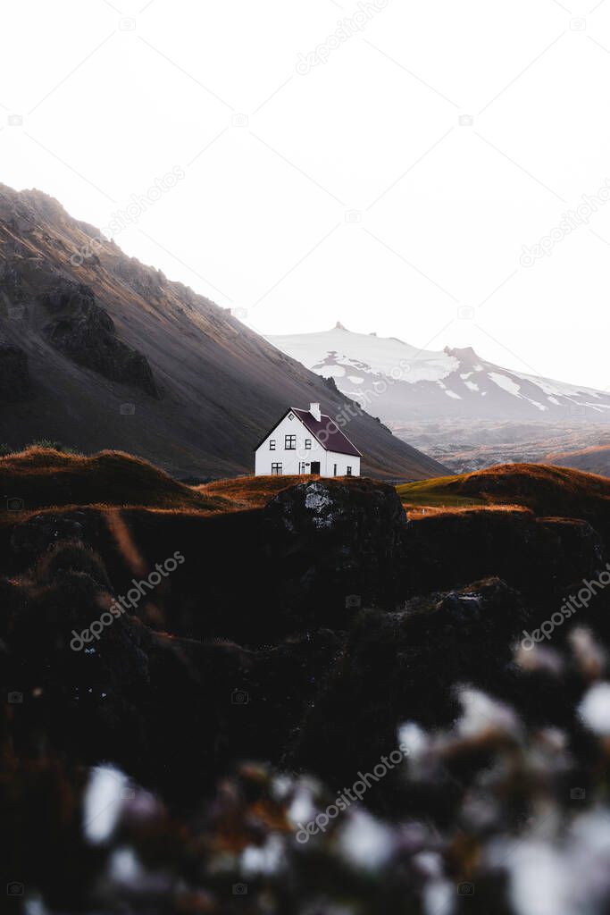 White house on a hill on a misty day in Iceland