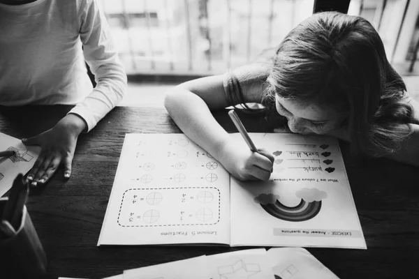 Young Caucasian Girl Doing Exercise Work Book Grayscal — Stockfoto