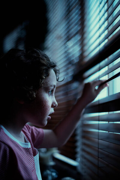Young Boy Looking Window Blinds Stock Image