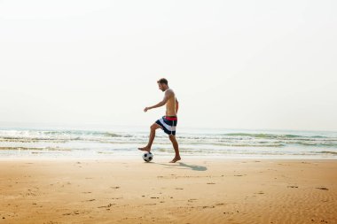 Man Beach Summer Holiday Vacation Football Concept