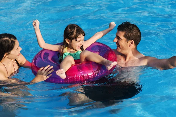 Mixed family enjoying summer pool time