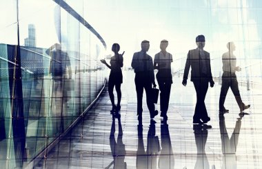 Silhouettes of Business People in Blurred Motion Walking clipart