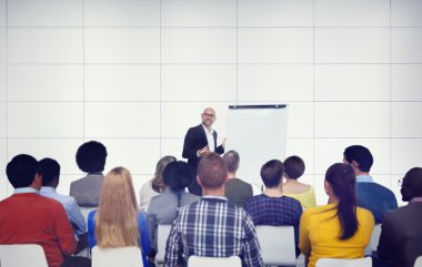 Businessman Presenting in Front of Audience clipart