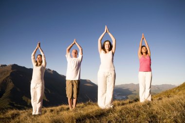 Group of people doing yoga clipart