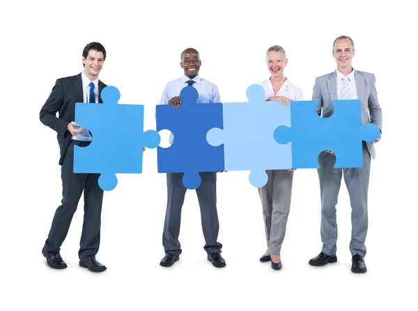 People holding pieces of jigsaw — Stock Photo, Image