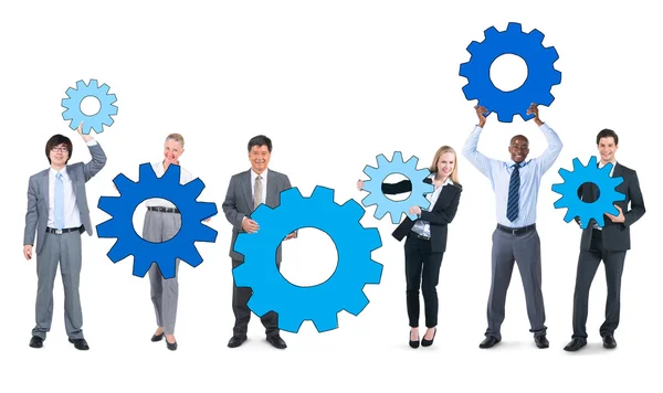 Business People holding gears — Stock Photo, Image