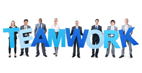 Mensen uit het bedrijfsleven houden woord teamwork — Stockfoto