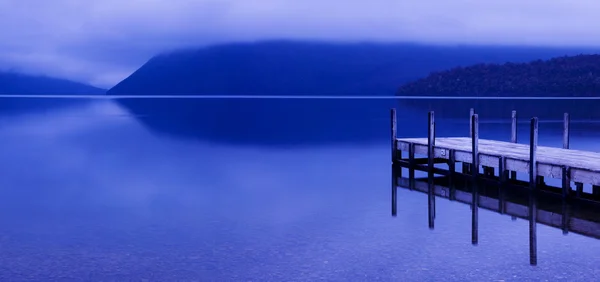Tranquil peaceful lake with jetty — Stock Photo, Image