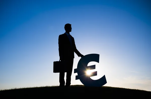 Businessman holding EURO currency sign — Stock Photo, Image