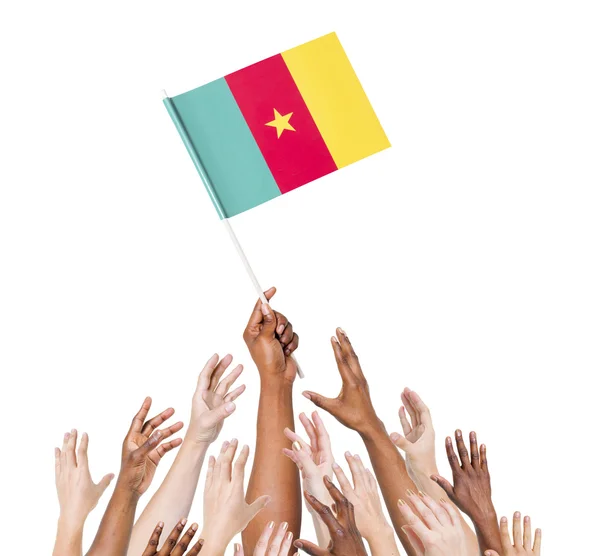 Human hand holding Cameroon Flag — Stock Photo, Image