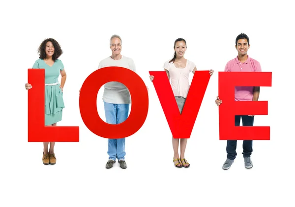 People holding 'LOVE' red letters — Stock Photo, Image