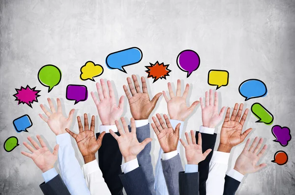 Business people's arms with speech bubbles — Stock Photo, Image