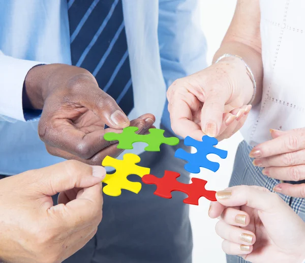 Business people connecting jigsaw together — Stock Photo, Image