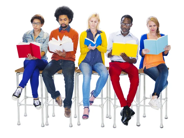 People Reading Books sitting on chairs — Stock Photo, Image