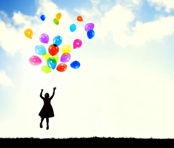 Flicka i luften hålla ballonger — Stockfoto