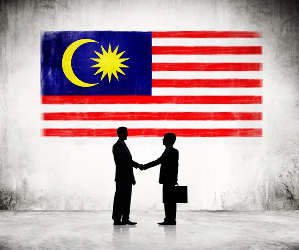 Businessmen Shaking Hands With Malaysian Flag — Stock Photo, Image