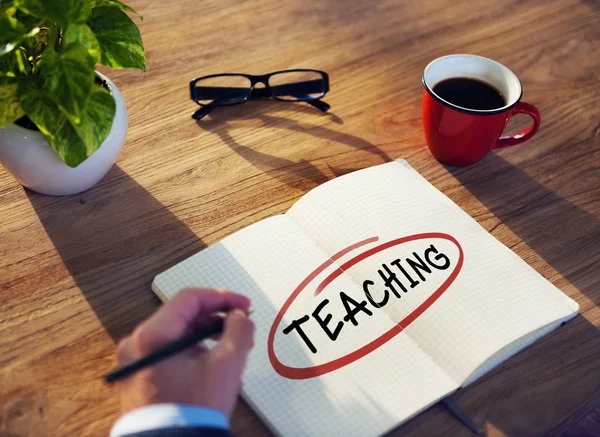 Businessman Writing 'Teaching' — Zdjęcie stockowe