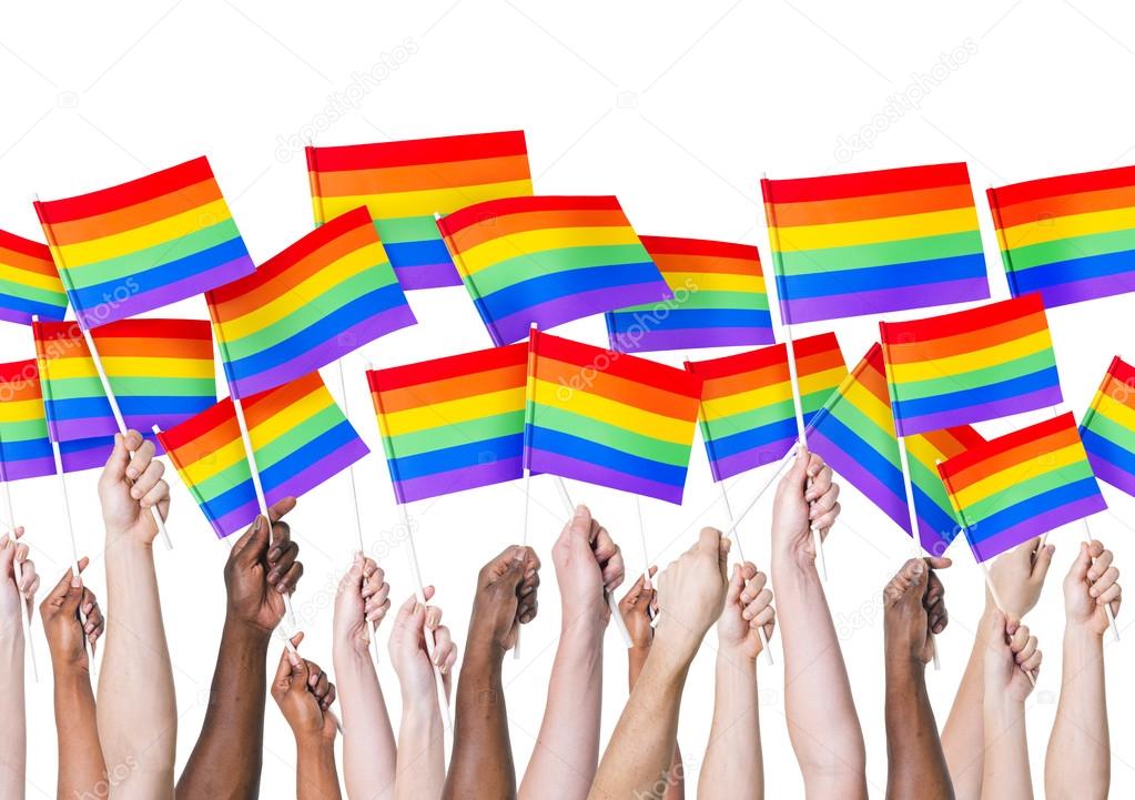People's hands holding LGBT Flags