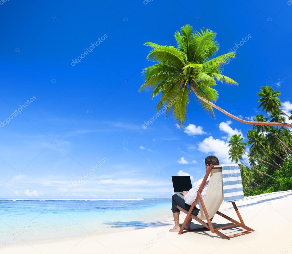 Businesman working at beach