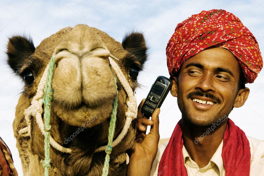 Man and camel in desert with communication