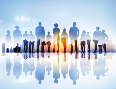 Silhouttes of Business People Looking Up in a Cityscape clipart