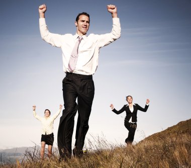 Business people running on mountain clipart