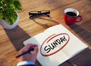 Businessman Writing 'Sunday'