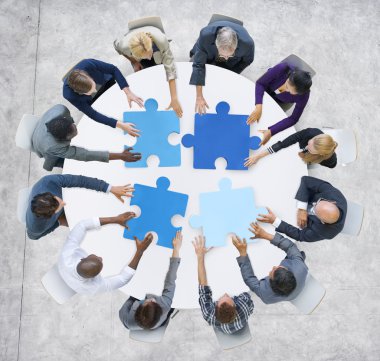 Business People and Jigsaw Puzzle Pieces clipart
