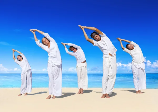 Persone che praticano yoga sulla spiaggia — Foto Stock