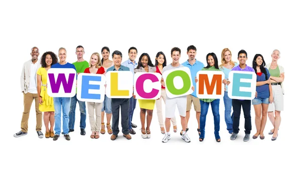 People holding placards forming welcome — Stock Photo, Image