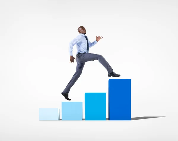 Businessman jumping on developing graph — Stock Photo, Image