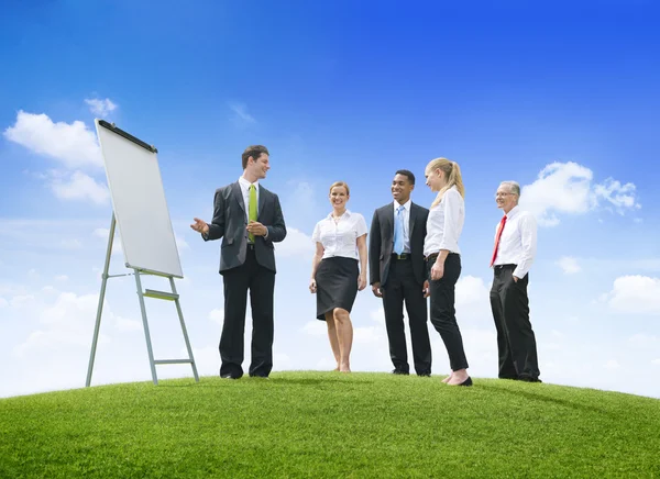 Businessman with presentation for colleagues — Stock Photo, Image