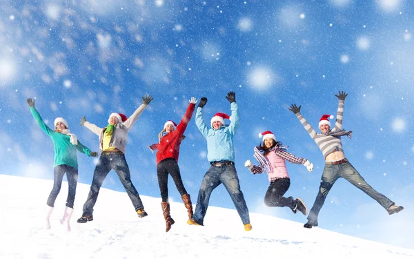 Friends jumping in snow — Stock Photo, Image