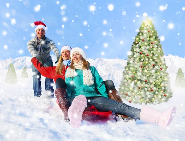 People sledding in snow — Stock Photo, Image