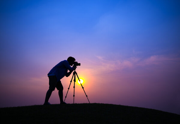 Photographer taking picture during sunset