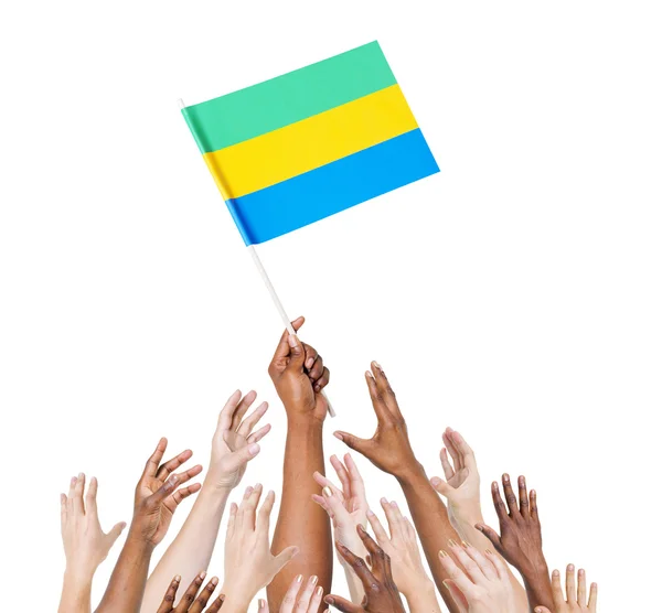 Arms holding flag of Gabon — Stock Photo, Image