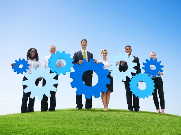 Business People Outdoors Holding Gears — Stock Photo, Image