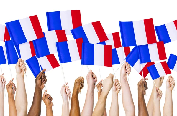 Händer som håller franska flaggor — Stockfoto