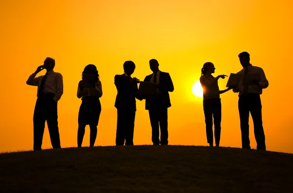 Business people having meeting at sunset — Stock Photo, Image