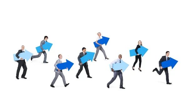 Personas corporativas sosteniendo signos de flecha azul —  Fotos de Stock