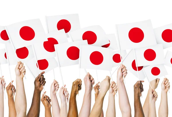 Руки с японскими флагами — стоковое фото
