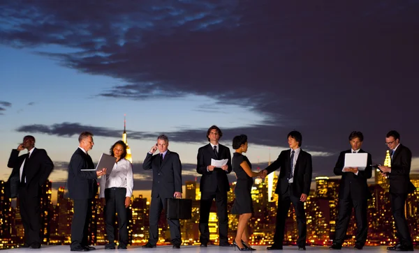 Business people working through dawn — Stock Photo, Image