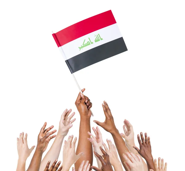 Human hands holding Iraq Flag — Stock Photo, Image