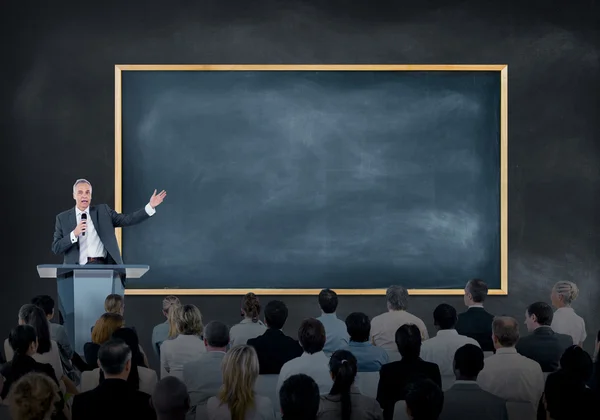 Presentation of a Speaker to a Large Group of Business People — Stock Image Presentation of a Speaker to a Large Group of Business People Royalty Free Stock Photos