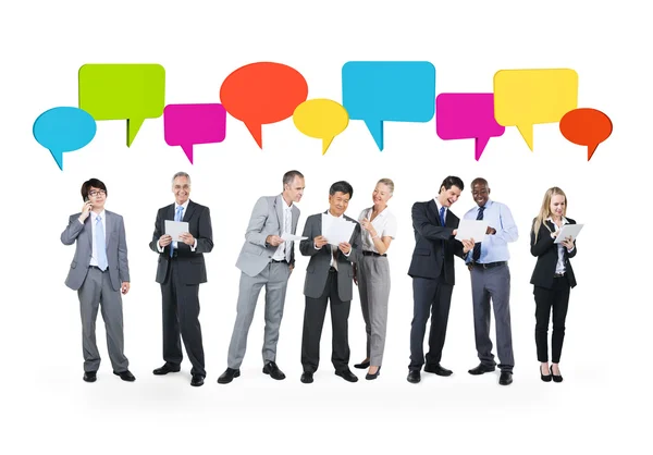 Business people with speech bubbles — Stock Photo, Image