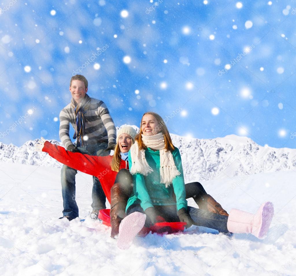 People sledding in snow