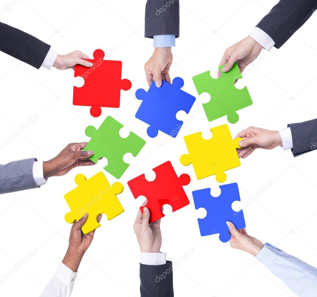 Hands of Business Teamwork holding puzzles