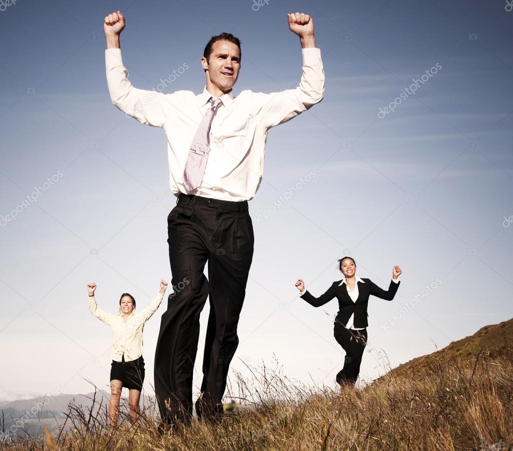 Business people running on mountain